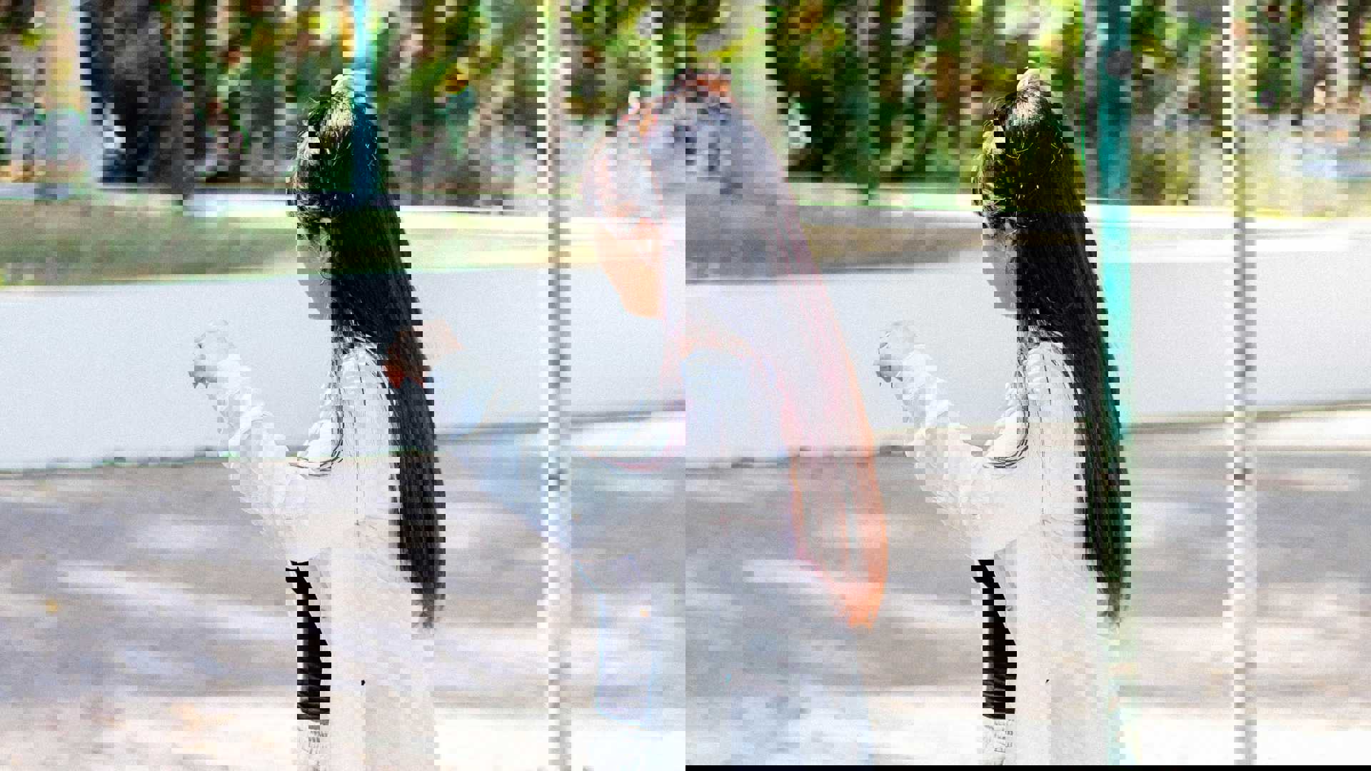 a woman riding a skateboard down a street