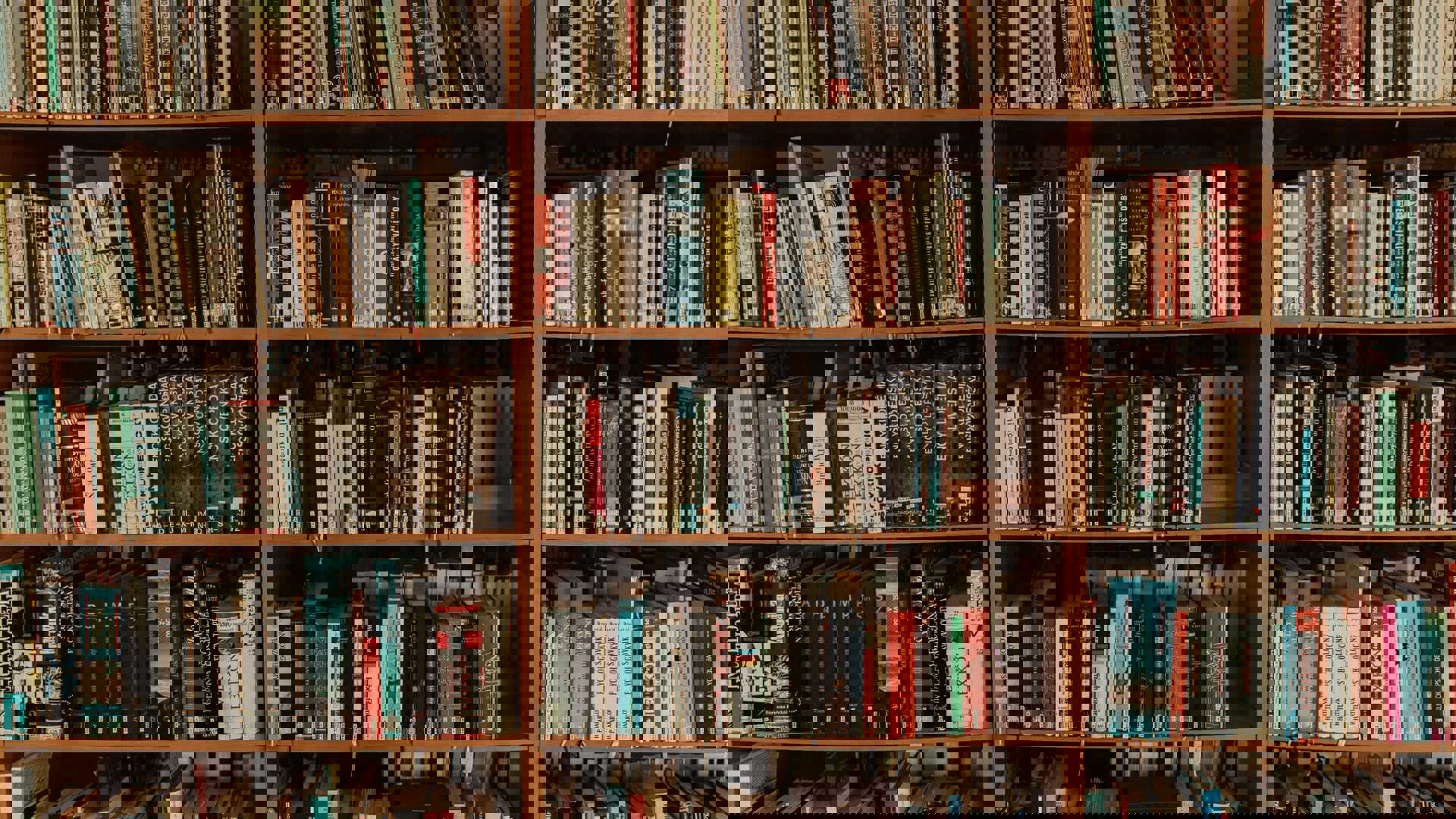 brown wooden book shelf with books